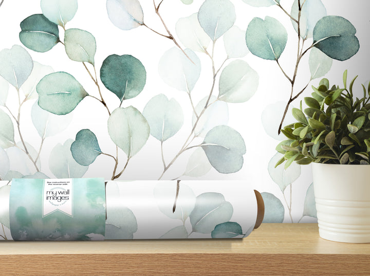 a wallpapered wall with a plant in a white pot placed on a wooden shelf.