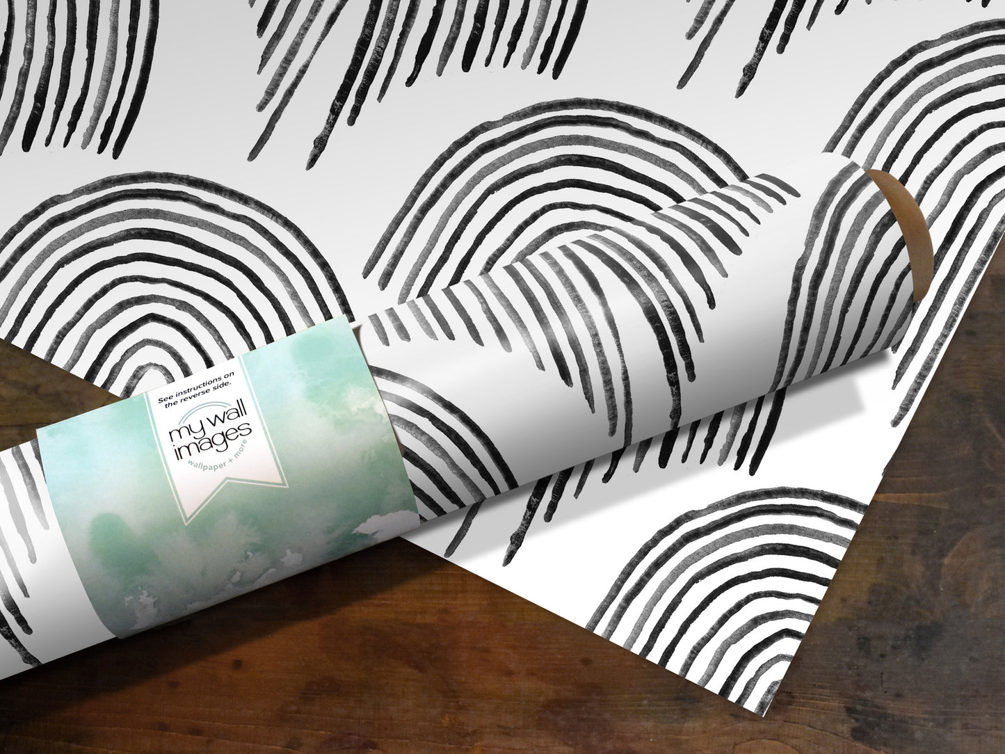 a roll of wrapping paper with a black and white striped pattern, placed on a wooden surface.