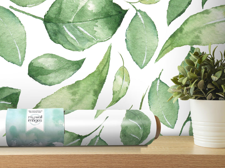 a wallpapered wall with a repeating pattern of green leaves, and there is a potted plant next to it on a shelf.
