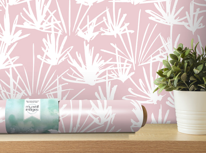 a pink and white abstract wallpaper pattern on a wall, with a potted plant placed next to it on a wooden shelf.