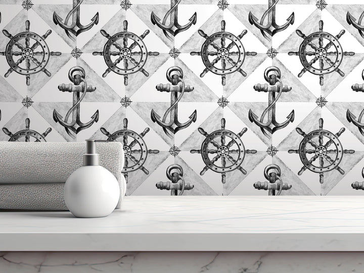 a white shelf with a white soap dispenser on it, set against a wall with a repeating pattern of black and white nautical-themed illustrations, including ship's wheels and anchors.
