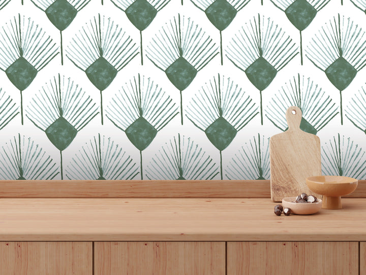 a wooden table with a wooden cutting board, a bowl, and a small wooden dish. The table is set against a wall with a repeating pattern of green and white leaf-like designs.