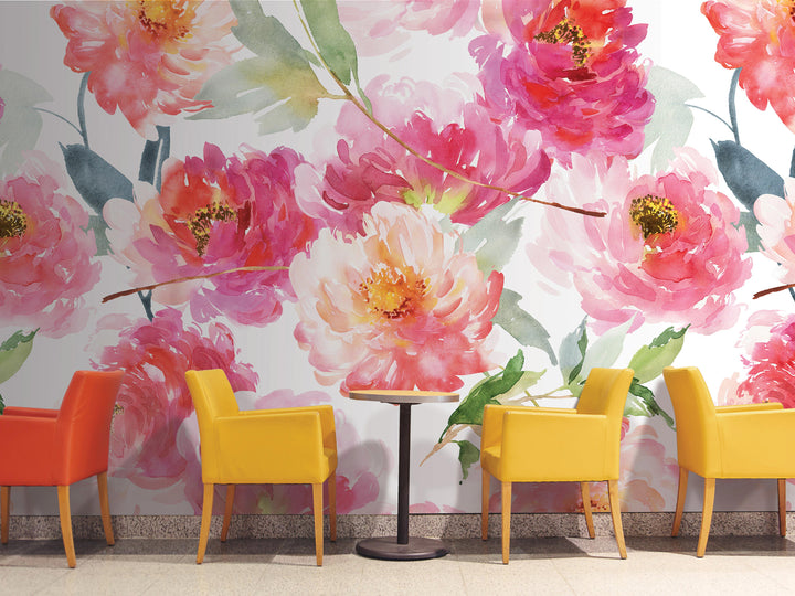 a vibrant floral mural on the wall behind a row of yellow chairs, creating a cozy and inviting atmosphere.