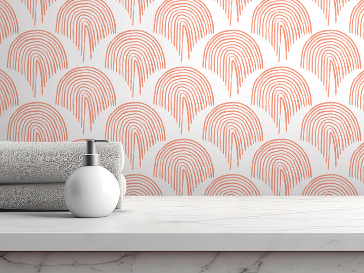 a white countertop with a white soap dispenser and a gray towel. The towel is neatly folded and placed on the countertop. The background of the image is a white wall with a repeating pattern of orange and red circles, creating a visually striking and modern design.