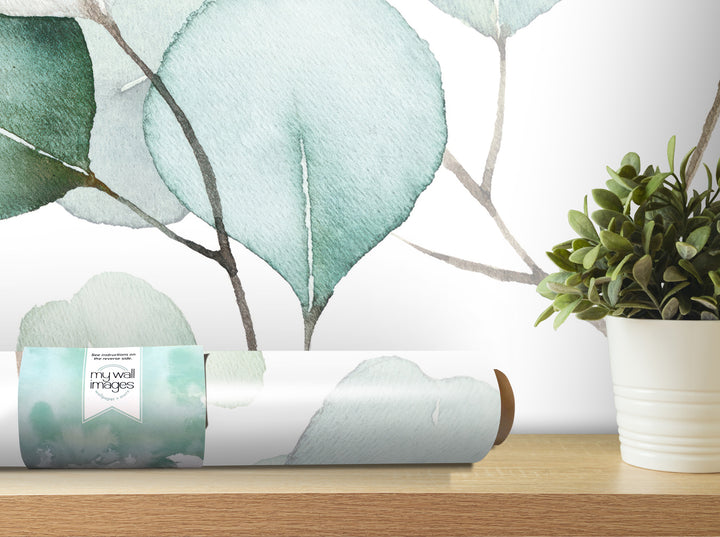 a wallpapered wall with a plant in a white pot on a wooden shelf, creating a serene and natural atmosphere.