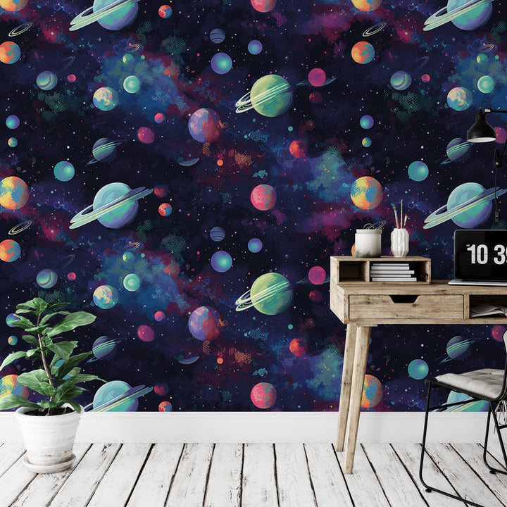 a wallpapered wall with a space-themed design, including planets, stars, and other celestial objects. There is a wooden desk with a laptop and a plant in the foreground, and a chair is visible in the background.
