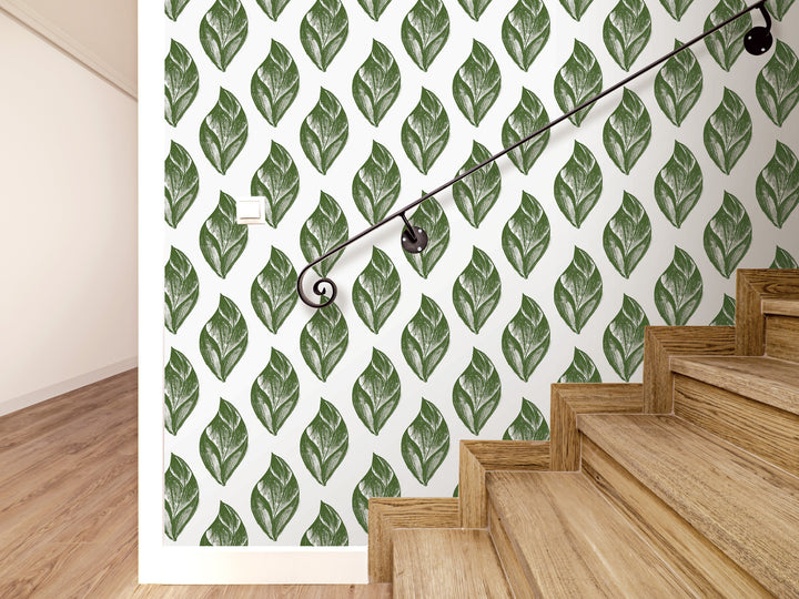 a wall with a repeating pattern of green leaf-like designs, creating a visually striking and nature-inspired backdrop. The wall is complemented by a wooden staircase with a black handrail, adding a touch of elegance and functionality to the space.