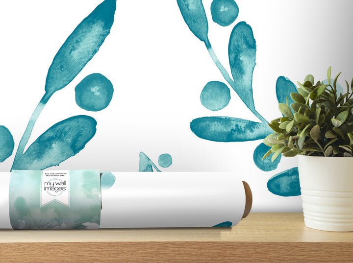 a white wall with a large blue leaf-like design and a potted plant on a wooden shelf.