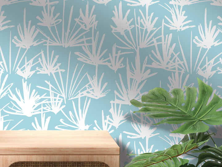 a wooden table with a plant on top of it, set against a wall with a patterned wallpaper.