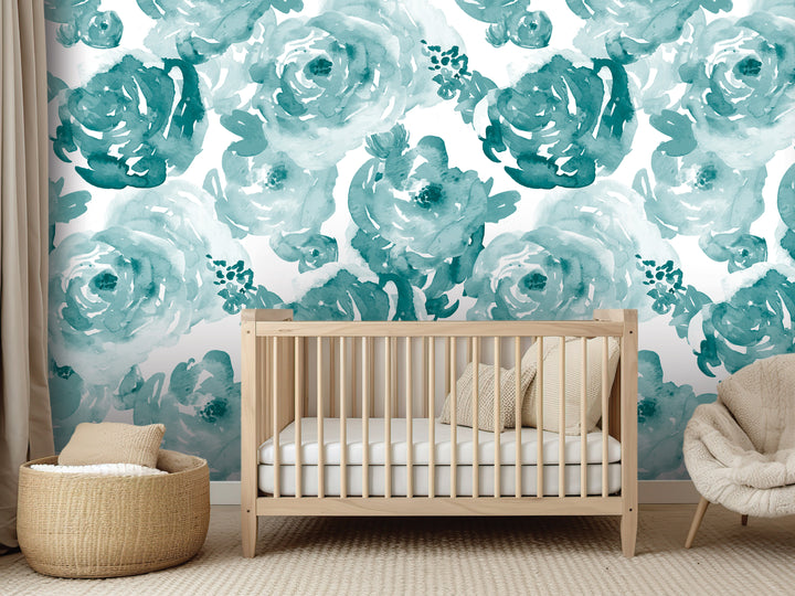 a nursery room with a wooden crib, a woven basket, and a plush chair. The walls are adorned with a large floral wallpaper in shades of blue and green, creating a serene and calming atmosphere.