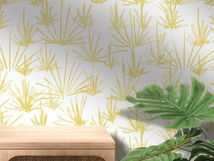 a wooden table with a plant on top of it, set against a wall with a repeating yellow and green patterned wallpaper.