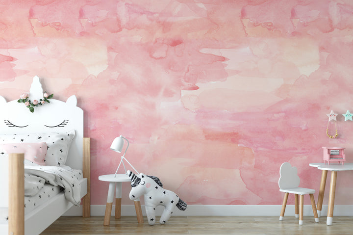 A child's bedroom with a pink and white color scheme, featuring a white bed with a unicorn headboard, a small table with a lamp, and a white chair.