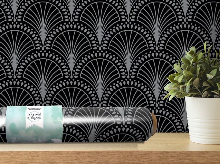 a black and white patterned wallpaper with a repeating fan-like design, and a potted plant placed on a shelf next to it.