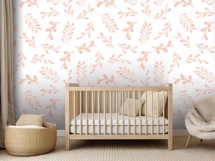 a nursery room with a wooden crib, a woven basket, and a plush chair. The walls are decorated with a repeating pattern of orange leaves and branches, creating a warm and cozy atmosphere.