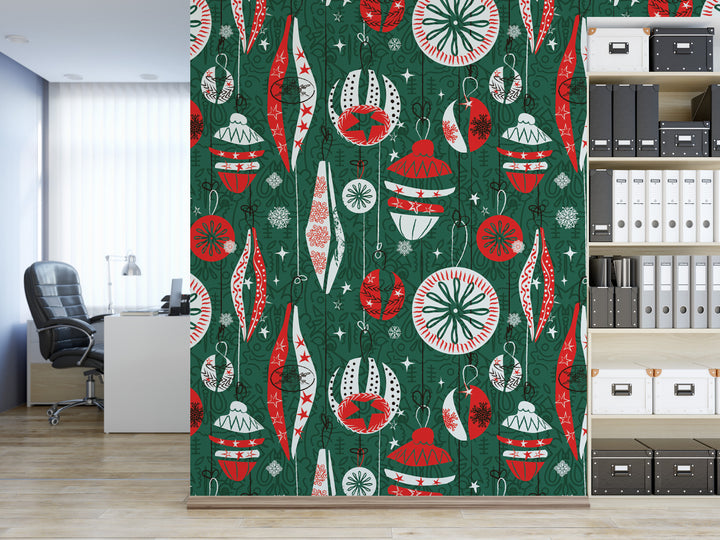 a wall with a vibrant, colorful pattern of Christmas ornaments and decorations in shades of green, red, and white. The pattern is displayed on a green background, creating a festive and holiday-themed atmosphere. In the background, there is a bookshelf filled with various books and binders, suggesting a workspace or study area.