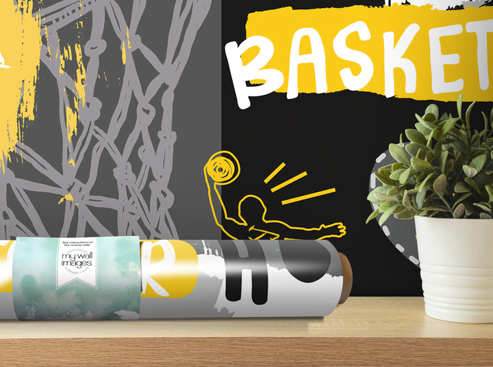 a poster with the word "Basket" written on it, along with a potted plant and a roll of wallpaper on a shelf.