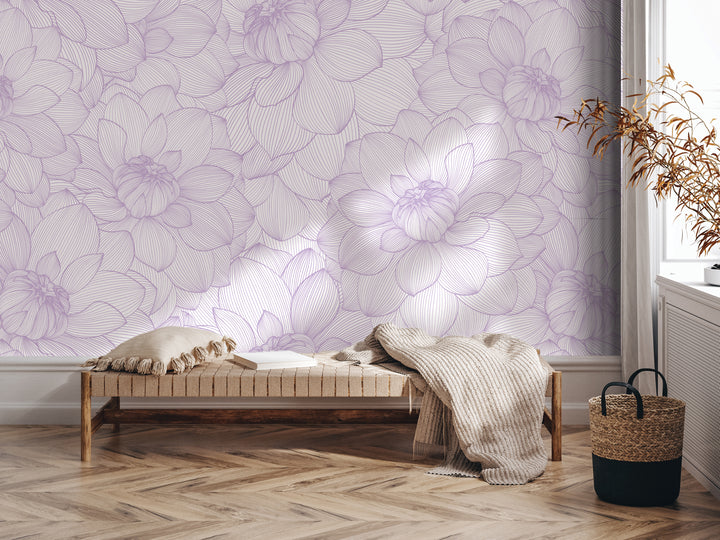 a cozy and inviting living space with a plush bench, a woven basket, and a decorative plant. The bench is positioned against a wall adorned with a large, intricate floral pattern in shades of purple and white, creating a serene and calming atmosphere.