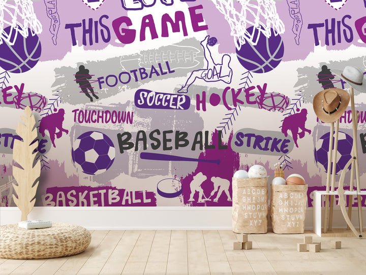 a wallpapered wall with various sports-related words and illustrations, including football, soccer, hockey, and basketball. There are also some wooden objects, such as a hat rack and a basket, placed in front of the wall.