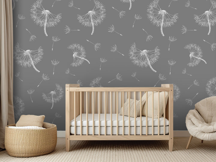 a nursery room with a wooden crib, a woven basket, and a plush chair. The walls are decorated with a gray and white pattern of dandelions, creating a serene and calming atmosphere.