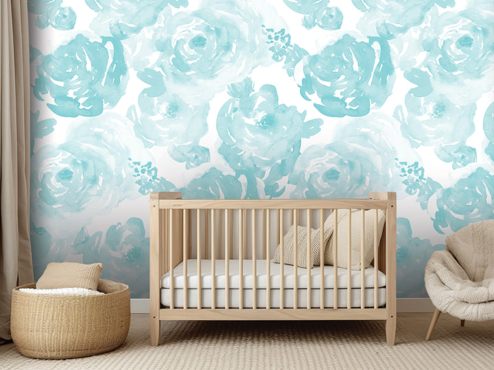a nursery room with a wooden crib, a woven basket, and a plush chair. The walls are adorned with a blue floral wallpaper, creating a serene and calming atmosphere.