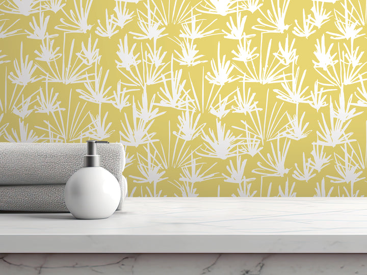a white soap dispenser on a white countertop, with a yellow and white patterned wallpaper in the background.