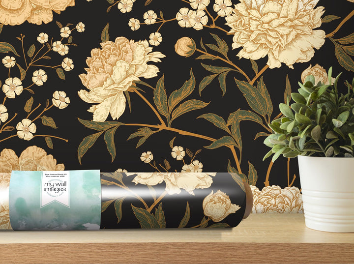 a vase with a plant next to a wall paper