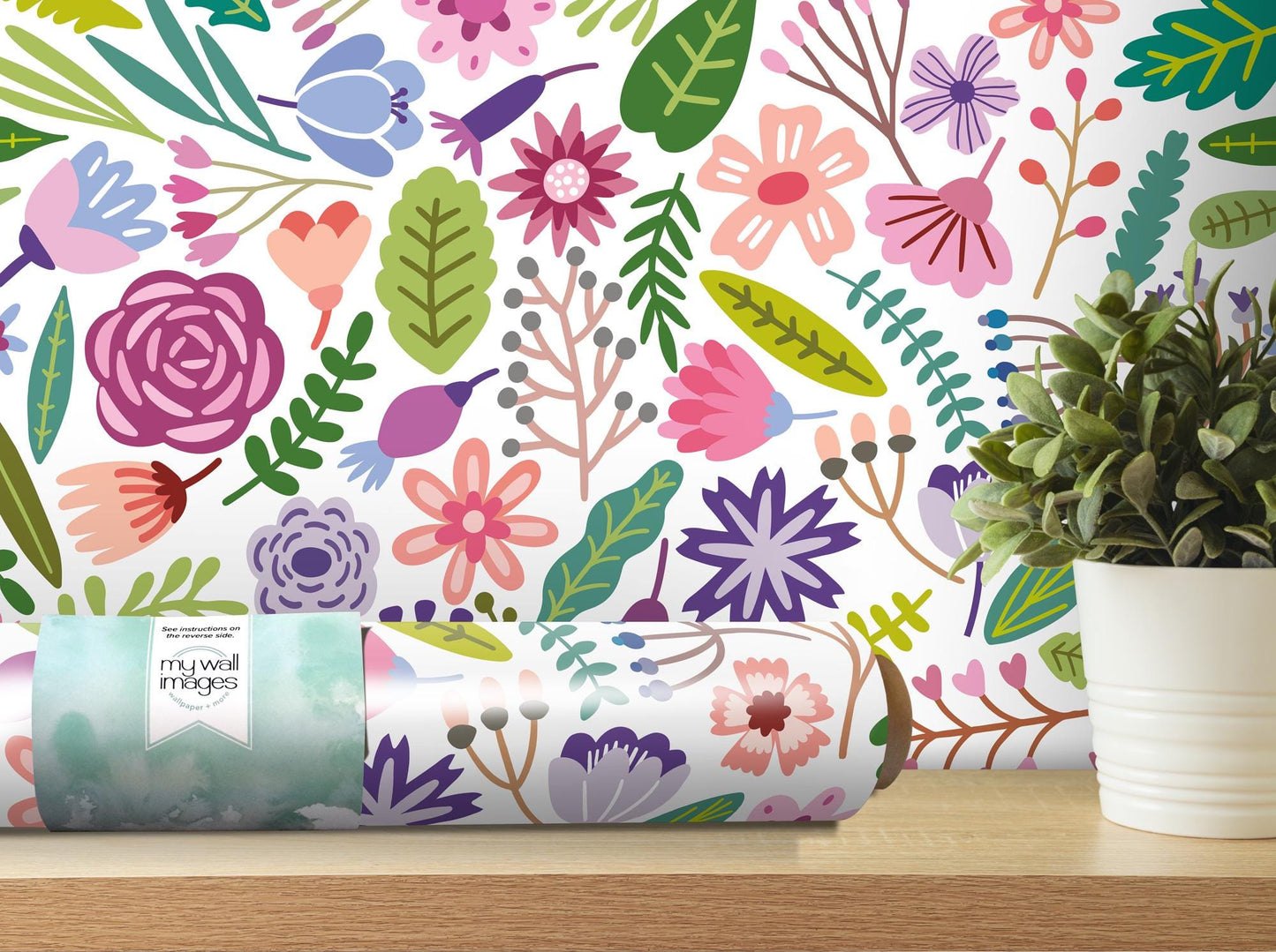 a vase with a plant on a table next to a wallpaper