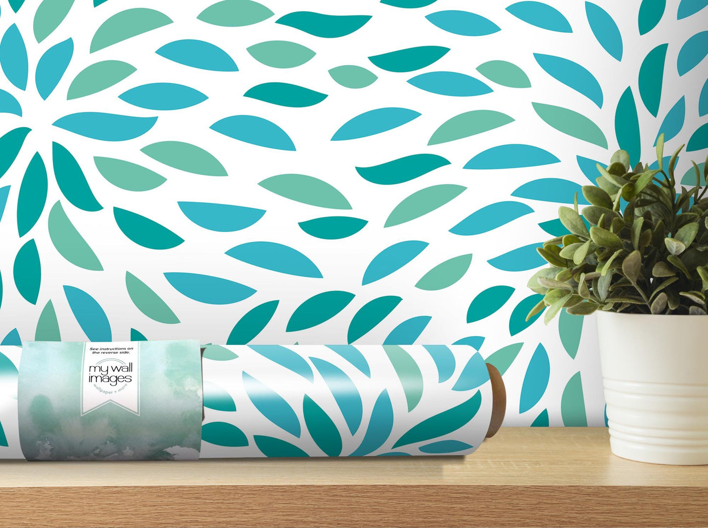 a vase with a plant on a table next to a wall paper