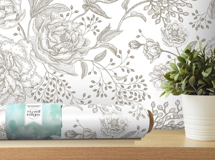 a vase of flowers and a rolled up paper on a table