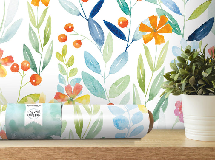 a painting of flowers on a wall next to a potted plant