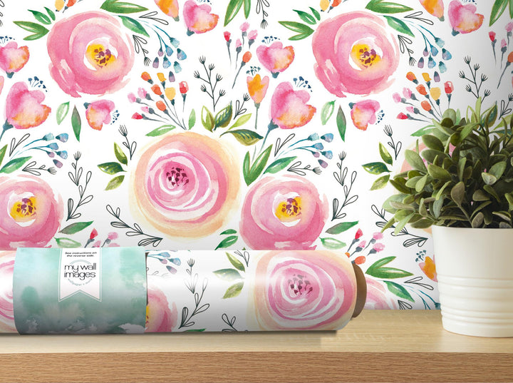 a painting of pink flowers on a wall next to a potted plant