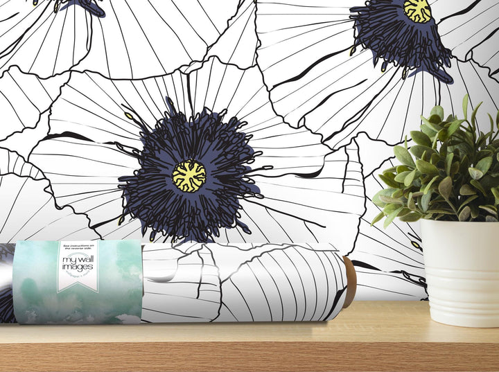 a white vase with a plant and a blue flower on a shelf