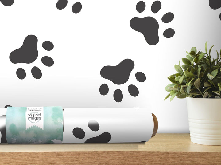 a white vase with a plant and a black and white wall