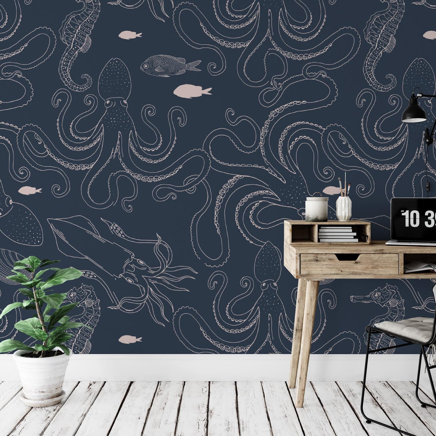 a desk and chair in a room with a wallpaper