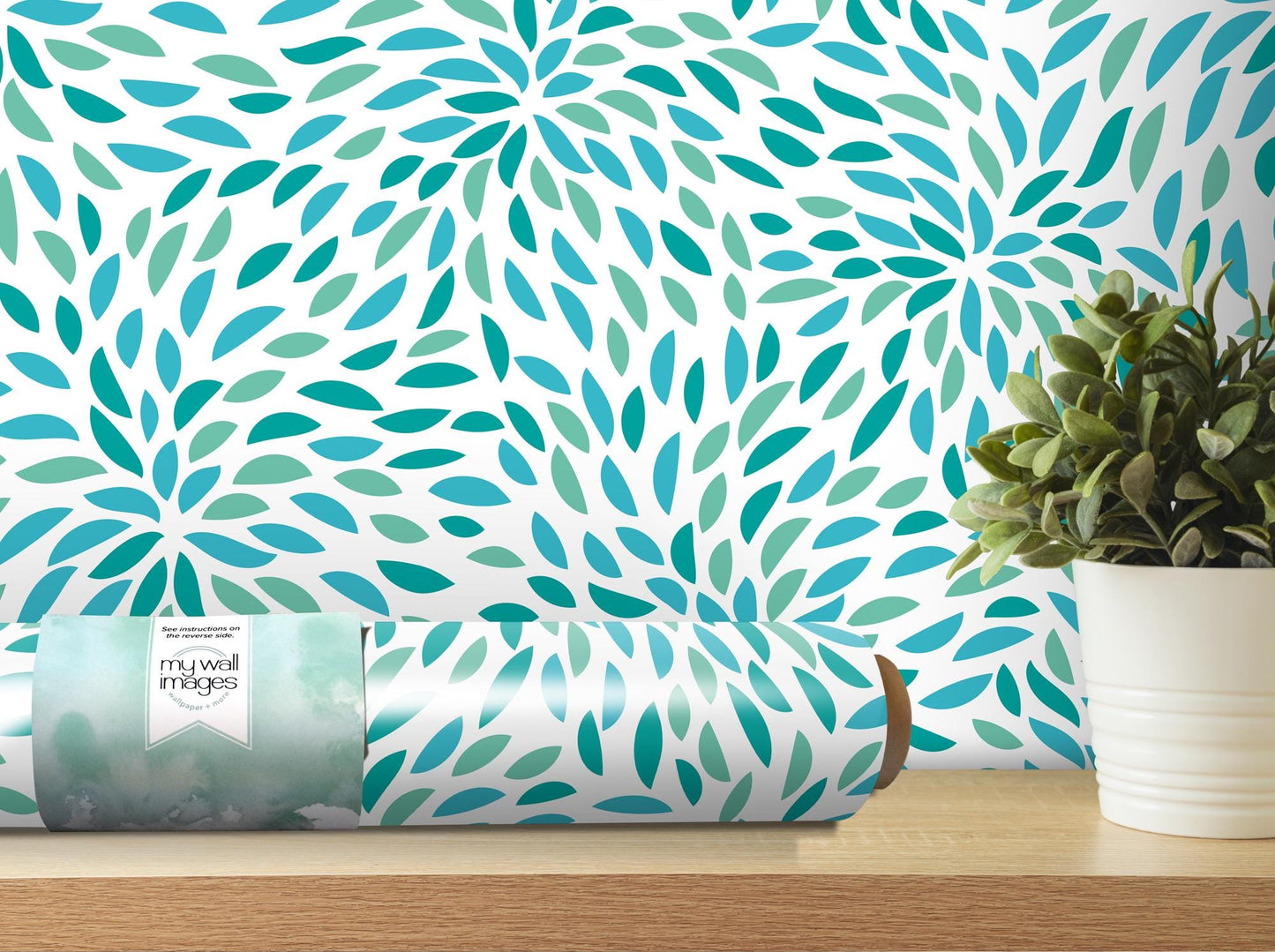 a vase with a plant next to a wall paper