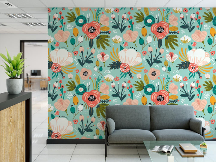 a living room with a couch and a flower wallpaper