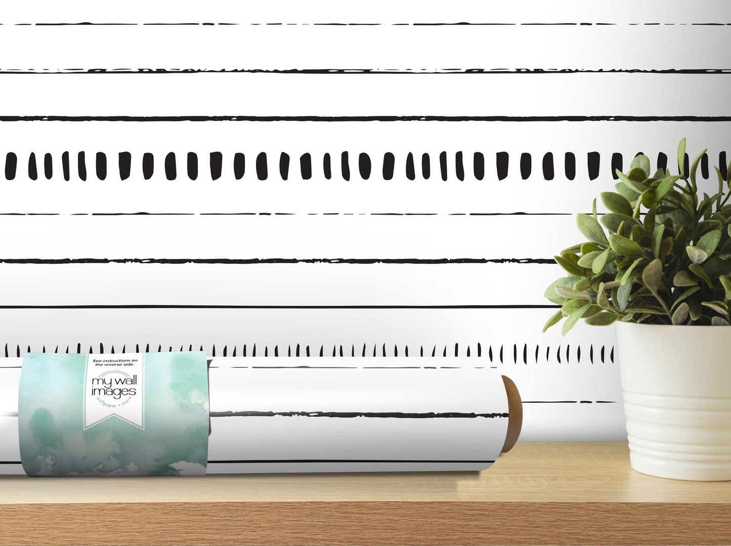 a white vase with a plant on a table