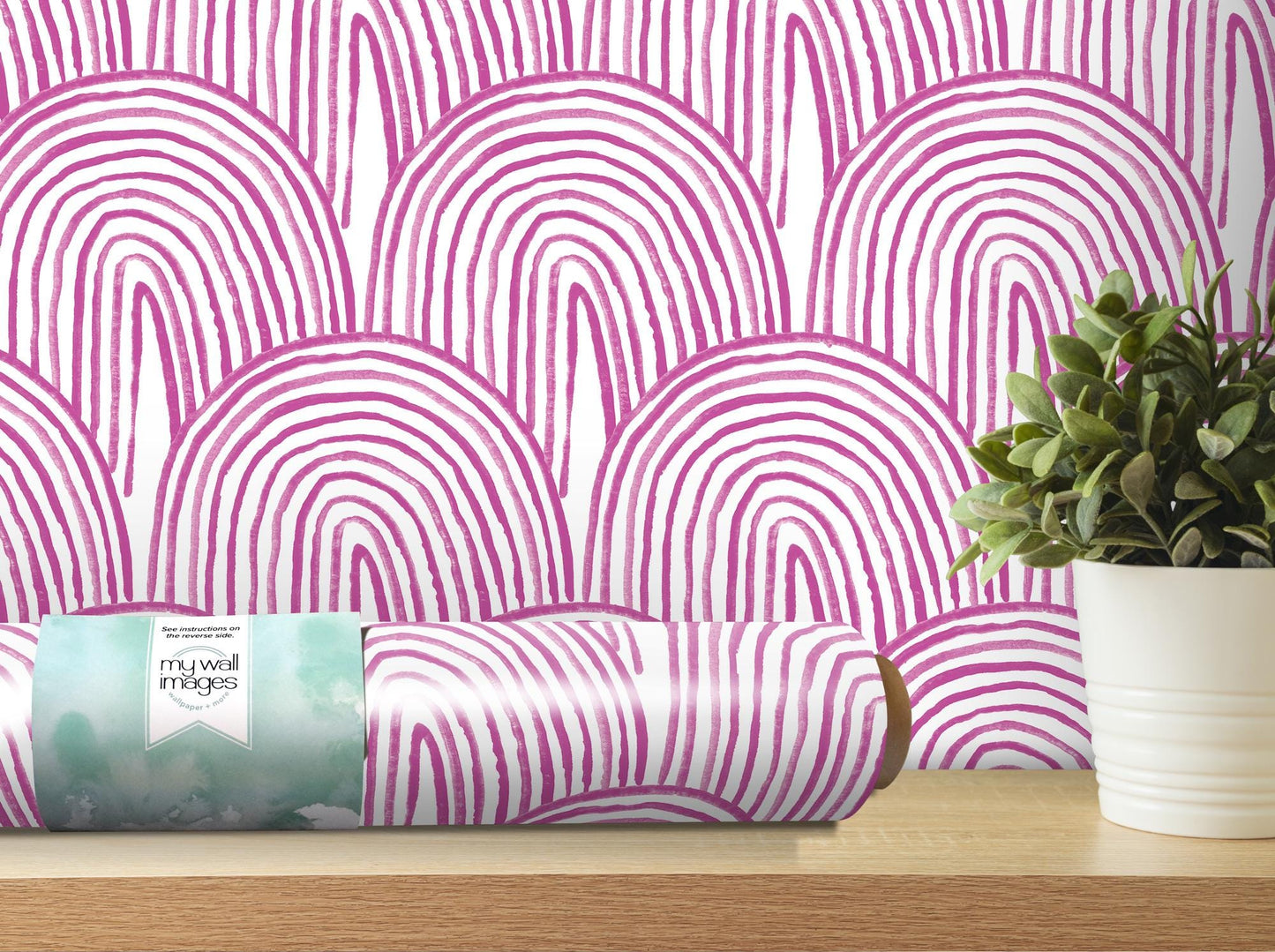 a pink and white wallpaper with a potted plant next to it