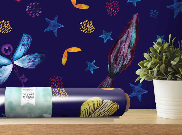 a vase with a plant next to a blue wallpaper