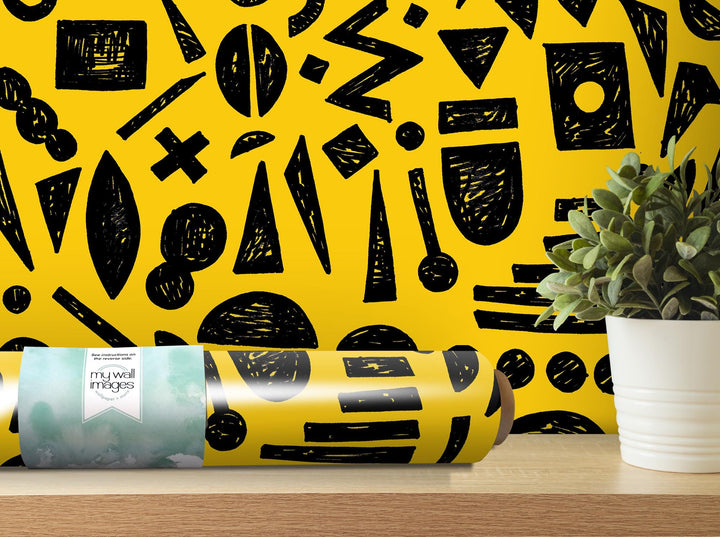 a yellow wall with a black and white pattern on it