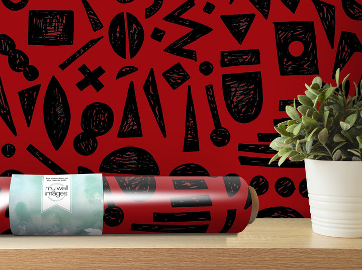 a plant is sitting on a table next to a red wall