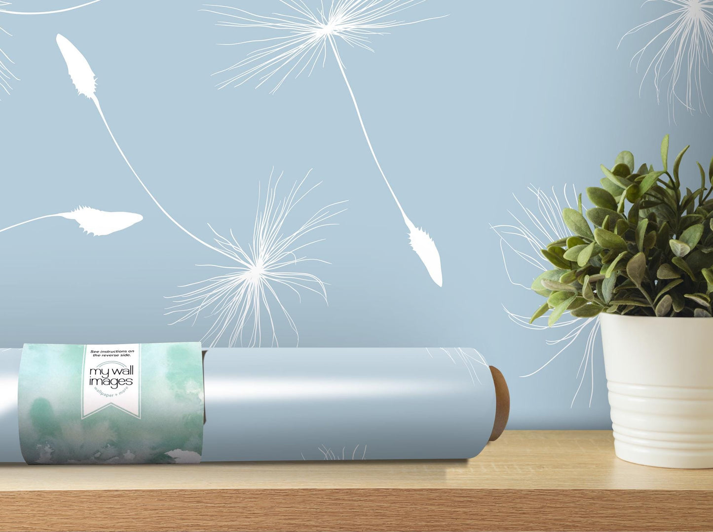 a vase with a plant in it next to a blue wall