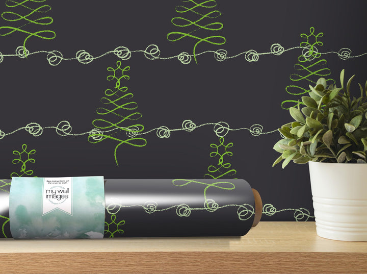 a vase with a plant next to a wrapped present