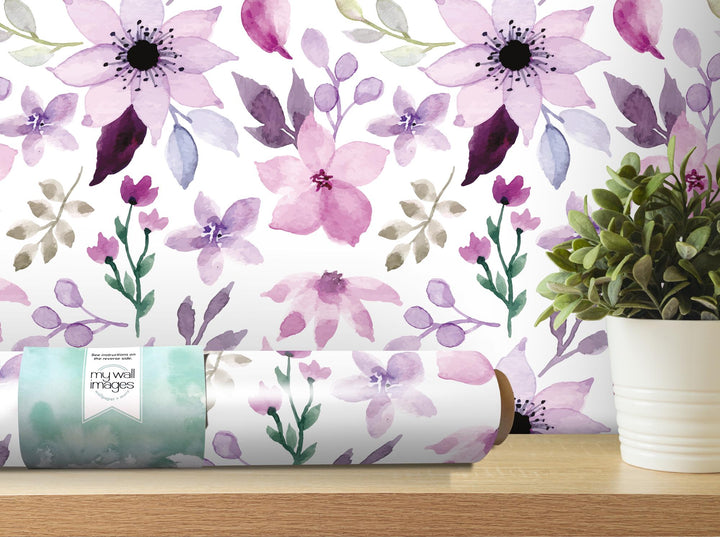 a vase with a plant next to a wall paper