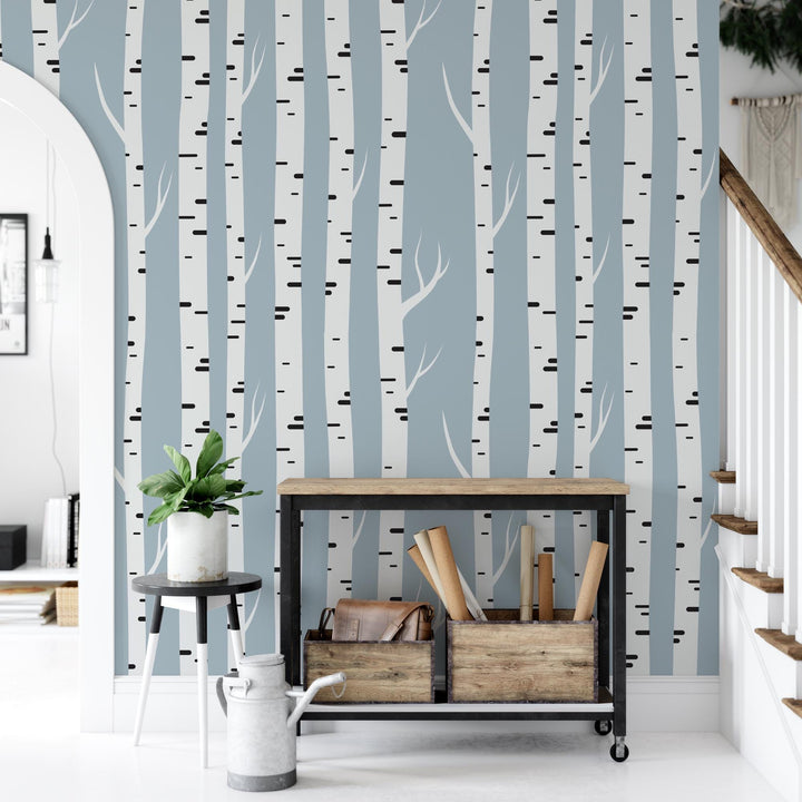 a room with a table and a wall with trees on it