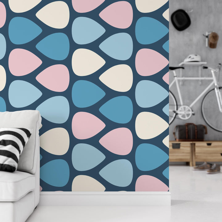 a living room with a white couch and a wallpaper