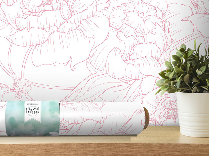 a plant is sitting on a table next to a roll of paper