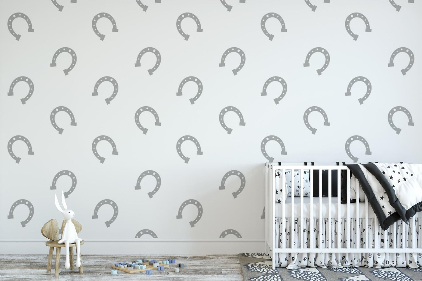 a baby's room with a crib and wallpaper
