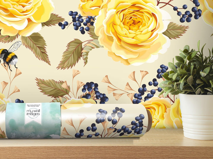 a vase of flowers next to a rolled up wrapping paper