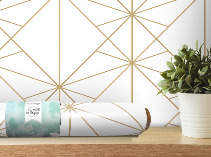 a white vase with a green plant on a table